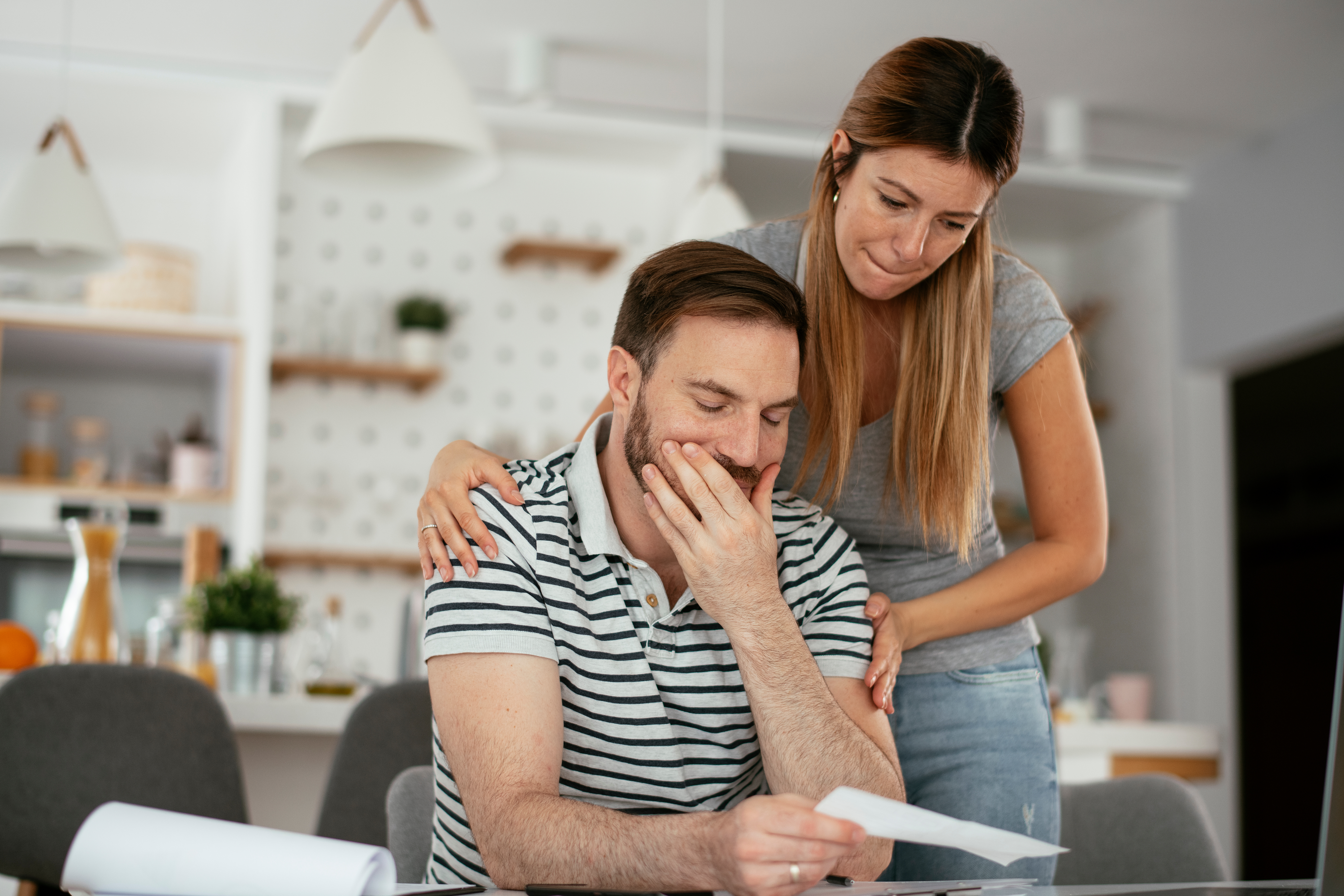 man sitting and a woman behind him