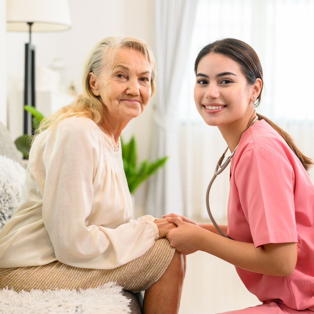 elderly woman holding hands with nurse