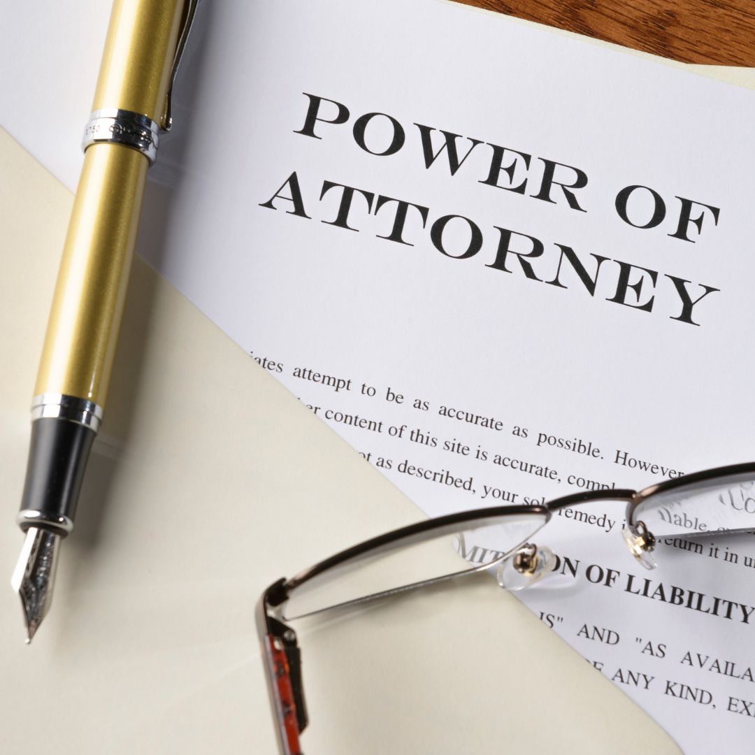 power of attorney paperwork, fountain pen and glasses