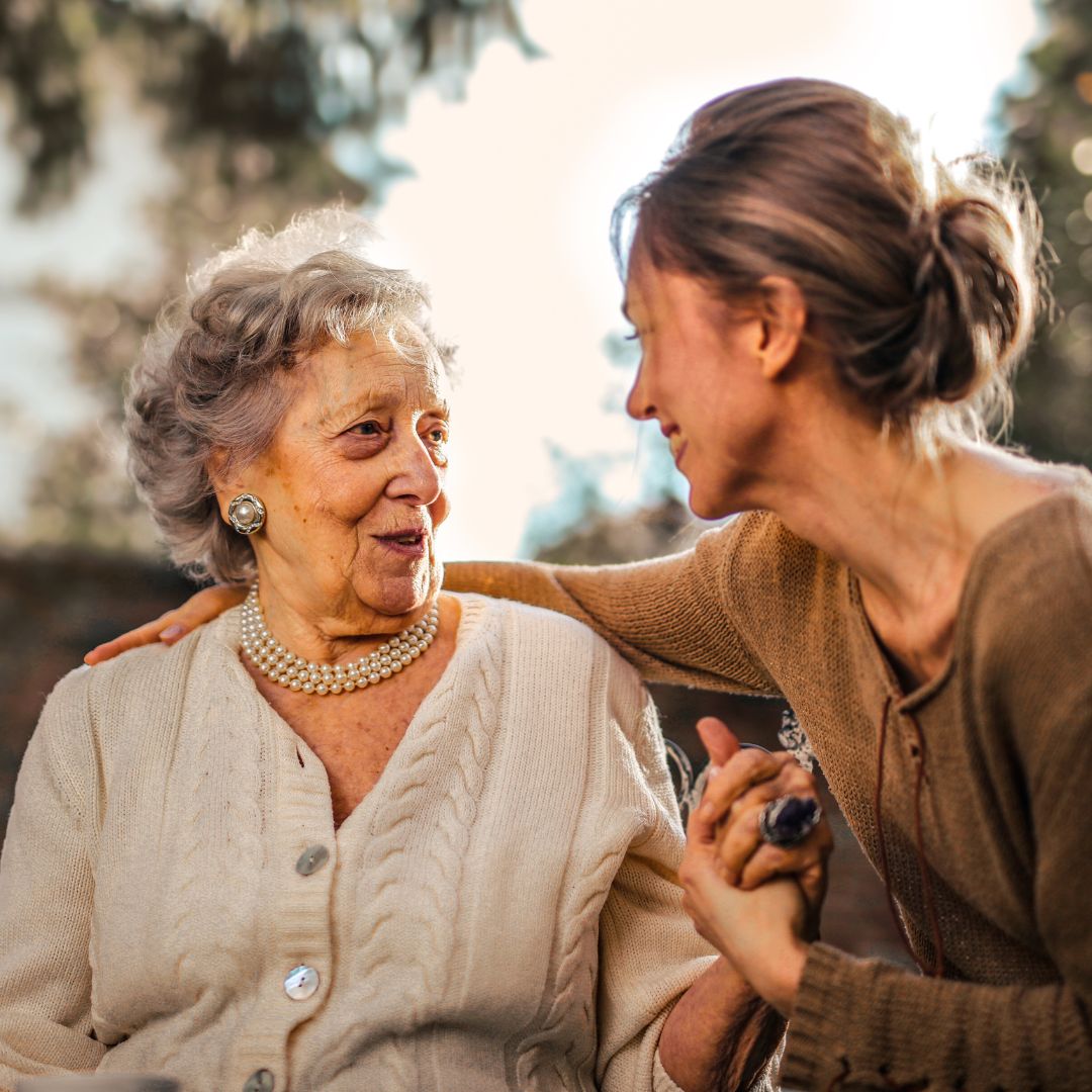 woman embracing and talking to grandmother