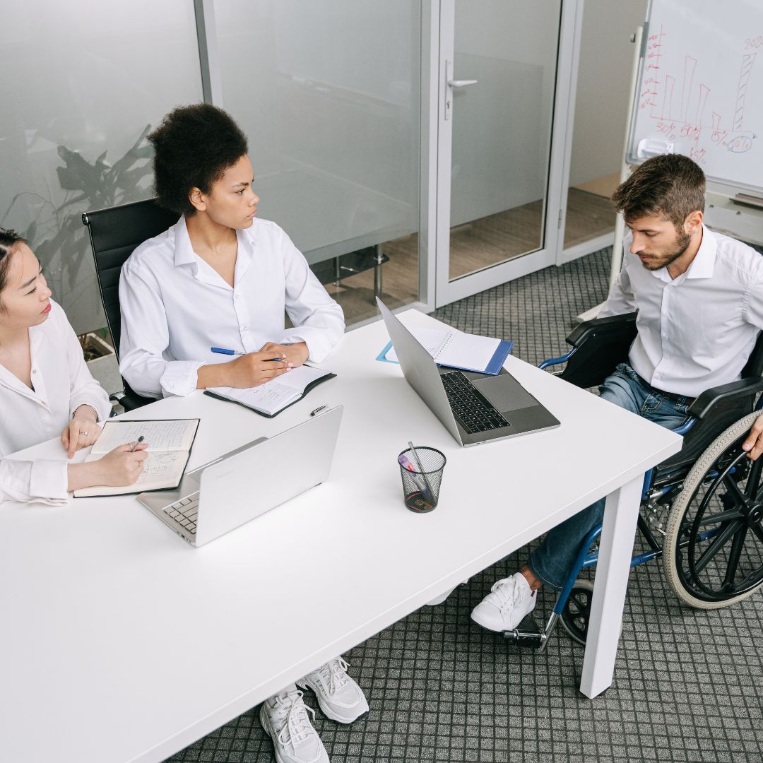 man in wheelchair at professional meeting