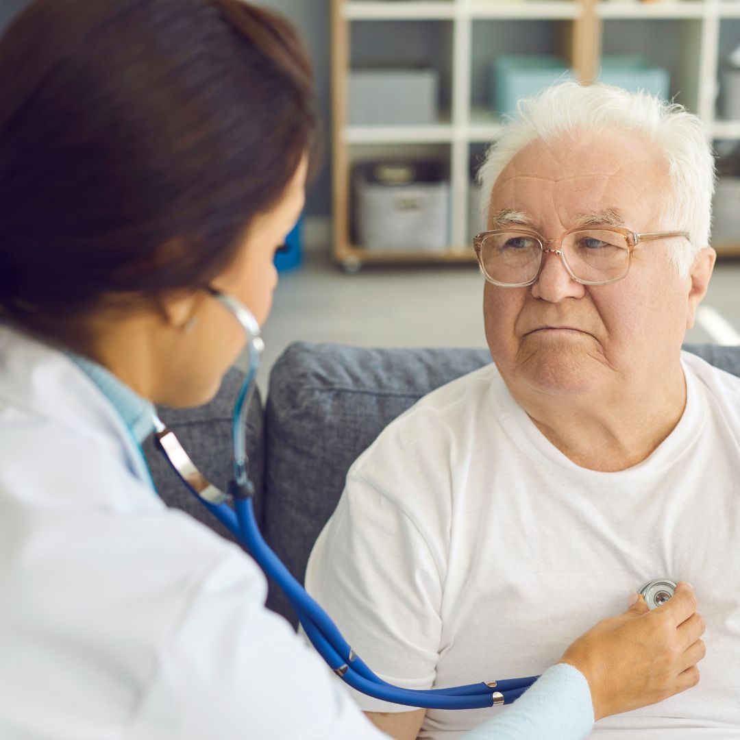 older man getting checked over by doctor