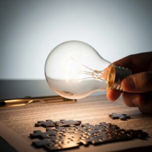 A lightbulb illuminating a complex legal document or puzzle.