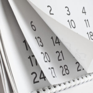 A calendar with a magnifying glass symbolizing the look-back period.